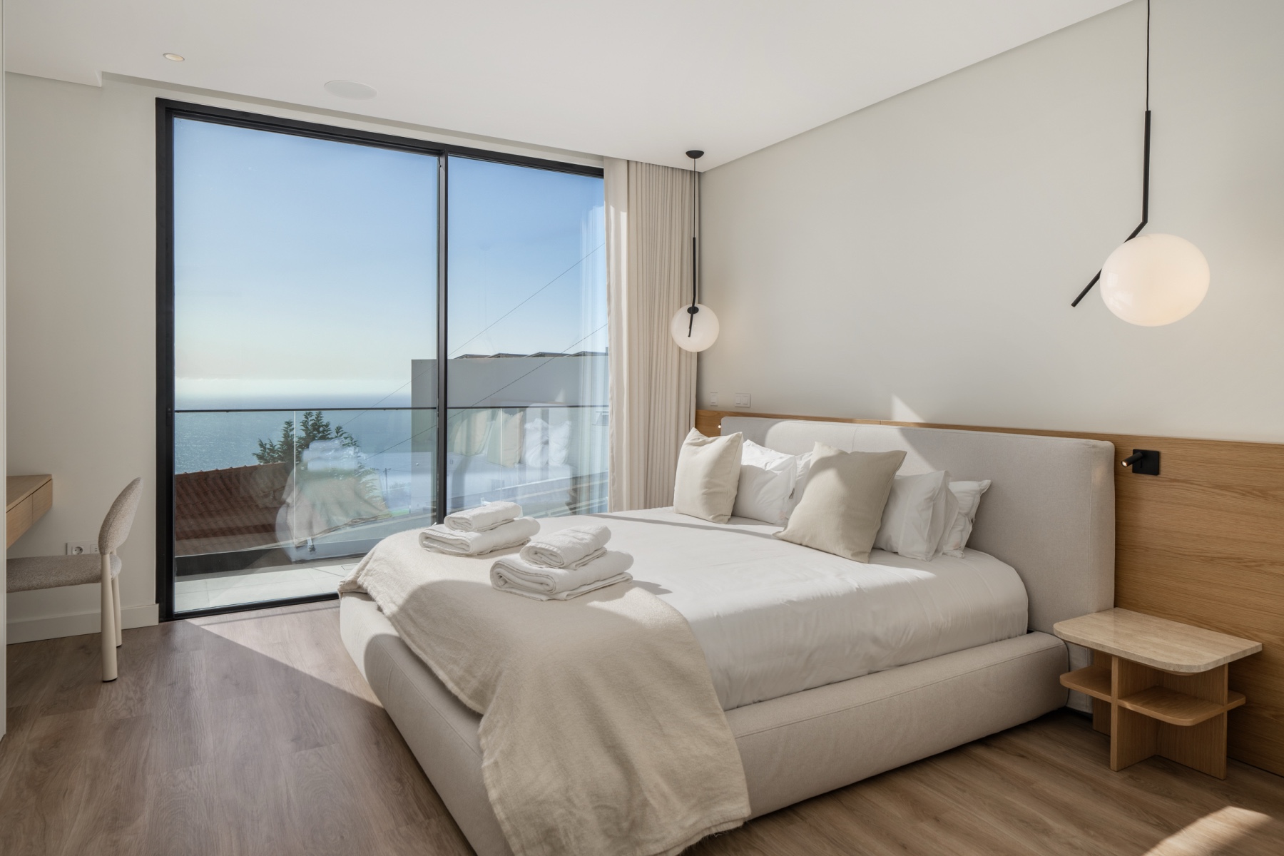 Guest bedroom workspace at Casa Amani with desk, external monitor, and natural light